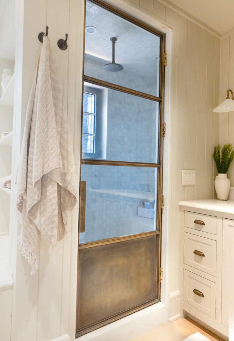 Custom brass and glass shower door by The Heirloom Companies
